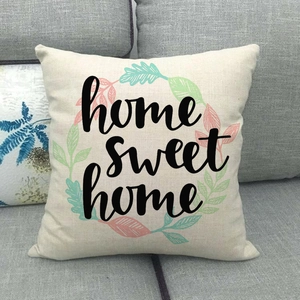 Linen decorative pillowcase featuring a floral wreath and Home Sweet Home text on sofa