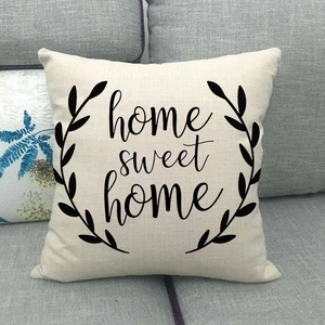 Linen pillowcase texture detail with Home Sweet Home text and laurel leaf print