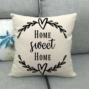Detailed texture of linen cushion cover featuring black Home Sweet Home floral print