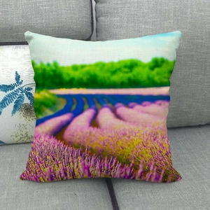 Detailed view of linen pillowcase with vibrant lavender field landscape on sofa