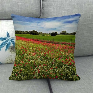 Macro detail of the woven linen texture and sunflower meadow landscape print on the pillowcase