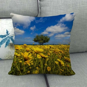 Detailed view of sunflower field landscape print on linen decorative throw pillow