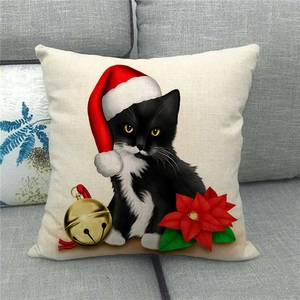 Detail of linen pillowcase with Christmas cat print and poinsettia flower decor