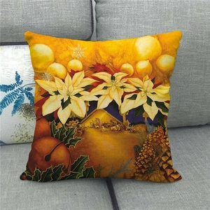 Christmas nativity linen pillow cover with festive flower prints on a grey sofa