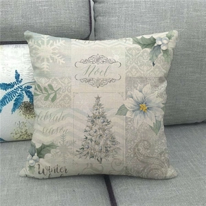 Close-up of linen pillow cover with Christmas tree, Noel print and festive snowflake details