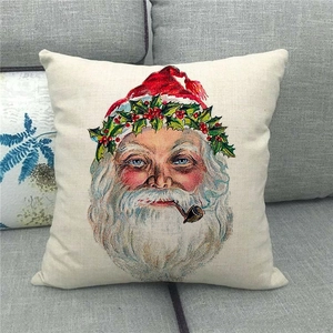 Retro linen Christmas pillow cover with Santa Claus print on a cozy grey sofa