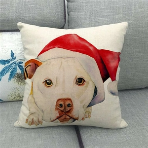 Linen Christmas pillowcase featuring a cute dog in a Santa hat on a cozy grey sofa