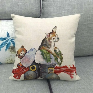 Detail view of linen pillow cover with festive dog and teddy bear illustration on a sofa