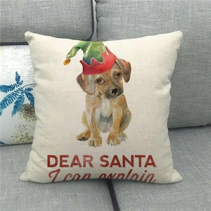 Detail of Christmas dog linen pillowcase with Dear Santa text on a grey fabric sofa
