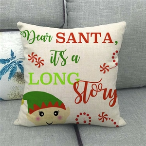 Detail of Christmas linen pillowcase with Dear Santa text and elf illustration on a sofa