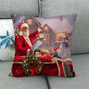 Merry Christmas linen pillowcase featuring Santa and snowman patterns on a grey sofa