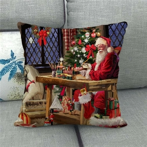 Close-up of a festive linen pillow cover featuring a vintage Santa workshop illustration