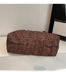 Detailed view of the soft leopard print canvas texture on this stylish tote bag