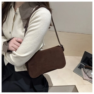 Detail shot of vintage dark brown faux suede shoulder bag for casual office commute