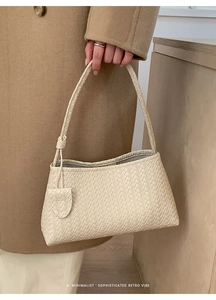 Close-up of woven cream shoulder bag showing leather craftsmanship and knot detail