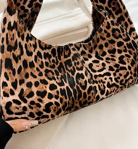 Close-up of leopard print tote bag showing PU leather texture and fine stitching detail