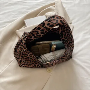 Spacious leopard print tote bag interior showing capacity for umbrella and phone