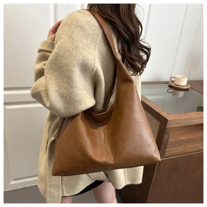 Detail view of the brown large capacity hobo bag showing vintage faux leather texture