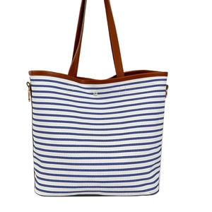 Striped canvas tote bag with brown leather handles and magnetic snap closure