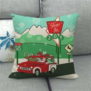 Close-up of linen Christmas pillow cover with vintage red truck and Santa Claus design