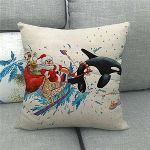Close-up of linen cushion cover with creative Santa Claus and whale surfing illustration