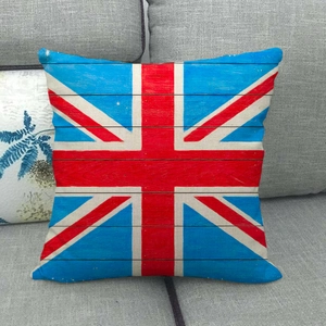 Detail of Union Jack linen pillow cover with vintage wood grain texture on grey sofa