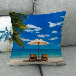 Linen pillow cover with tropical beach landscape print on gray sofa background