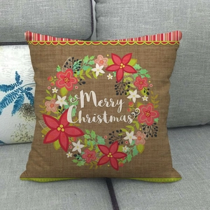 Détail de la taie d'oreiller de Noël en lin avec couronne sur un canapé gris