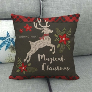 Weihnachts-Kissenbezug aus Leinen mit Elchmotiv und Schriftzug auf einem Sofa