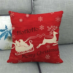 Detail of red linen Christmas pillow cover with reindeer silhouette and Merry Christmas print