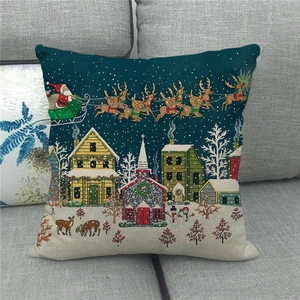 Detail of linen Christmas pillowcase featuring a Nordic winter village scene on a sofa