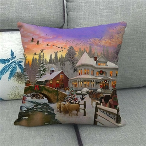Linen pillow cover featuring a winter countryside snow scene with sunset on a gray sofa