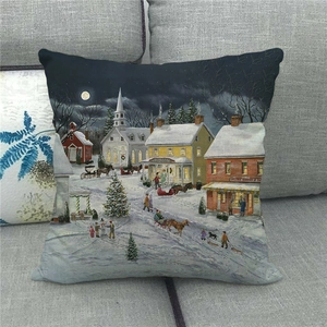 Detailed close-up of a festive linen pillow cover featuring a winter village snow scene