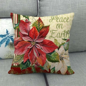 Poinsettia linen pillow case on grey sofa with Peace on Earth festive printing