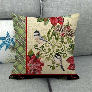 Detail of Christmas pillow cover with bird and flower print on grey fabric sofa