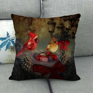 Detail view of textured linen pillowcase with festive cardinal birds and retro street lamp