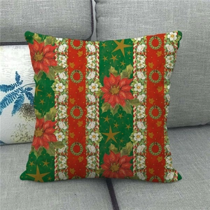 Close-up of linen Christmas pillow case with red poinsettia and striped pattern on sofa