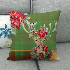 Detailed close-up of a green plaid Christmas pillow cover with reindeer and bird print