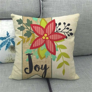 Detailed macro view of the Joy floral linen throw pillow cover on a grey fabric sofa