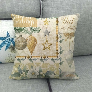 Detail of Christmas linen pillowcase with festive ornaments on a grey sofa