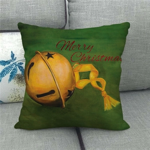 Detail of linen Christmas pillow case with festive gold bells and Merry Christmas text
