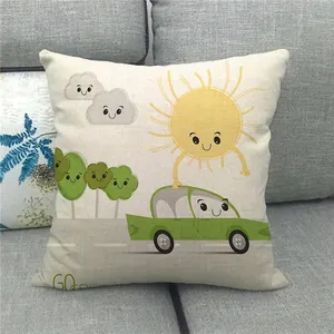 Close-up of linen pillowcase featuring cartoon sun and car design on a grey sofa