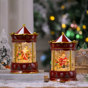 Christmas carousel snow globe with Santa and music, warm holiday light scene