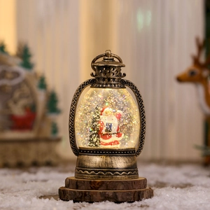 Detail of vintage Christmas lantern with Santa scene and snow on rustic wood base