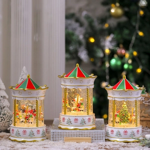 Three illuminated Christmas carousel snow globes with music and glowing glitter effects