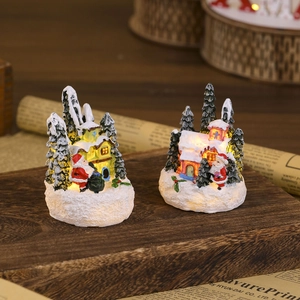 Detail of light-up resin Christmas miniature houses with Santa and warm LED glow