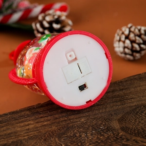 Detail view showing bottom battery compartment and black power switch of Christmas lantern