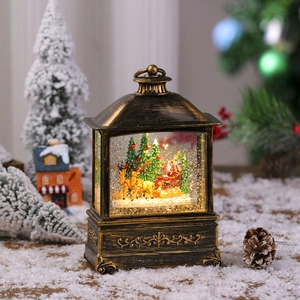 Close-up of vintage bronze Christmas lantern featuring Santa and reindeer in snow