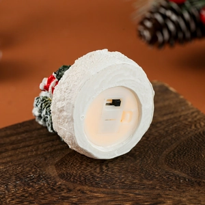 Close-up of the battery compartment and power switch on the Christmas resin house base