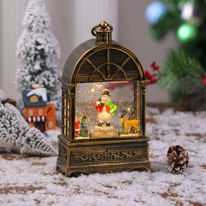 Close-up of vintage bronze snow globe lantern with snowman and golden reindeer scenery